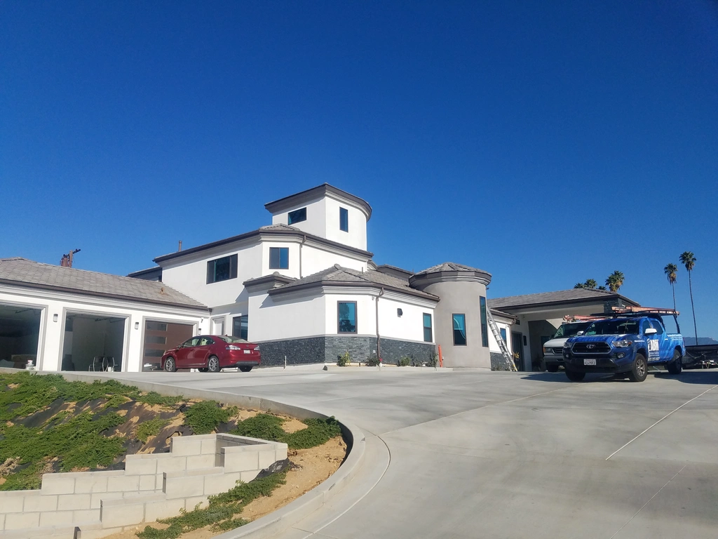 Modern Home Exterior With Vehicles Abm Window Cleaning